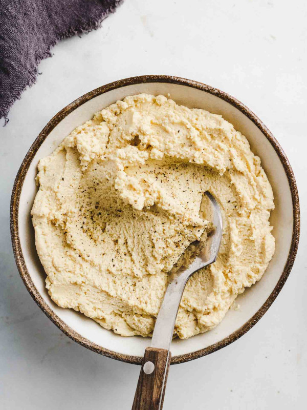 vegan tofu ricotta in a bowl with a spread knife
