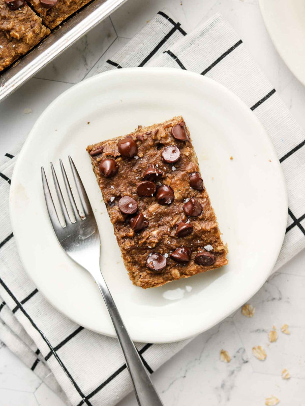 banana oatmeal bars with chocolate chips on top on a plate