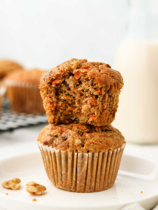 vegan carrot muffins stacked with a bite shot