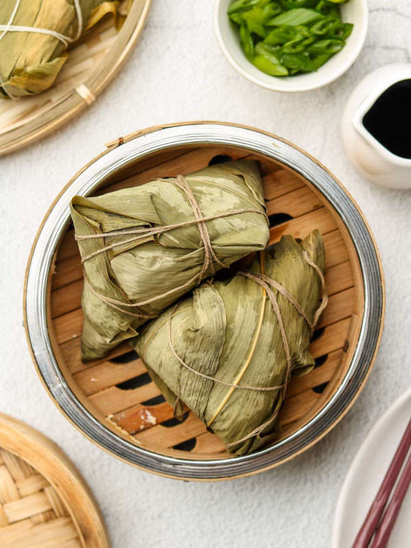 chinese sticky rice in a bamboo steamer basket