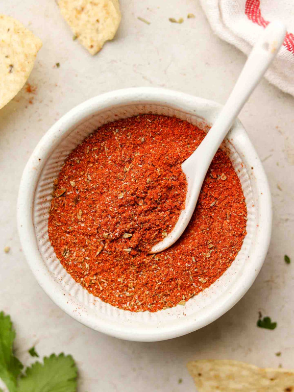taco seasoning in a white bowl with a spoon inside
