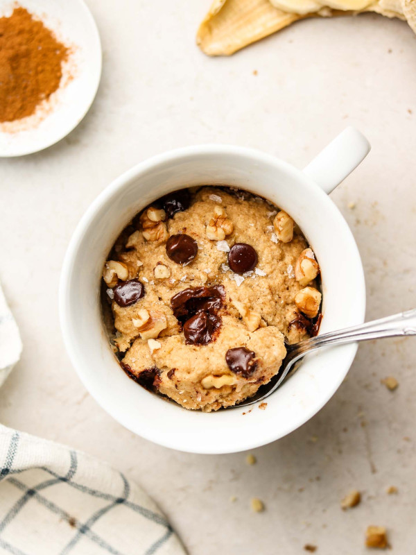 banana bread mug cake with chocolate chips and walnuts on top