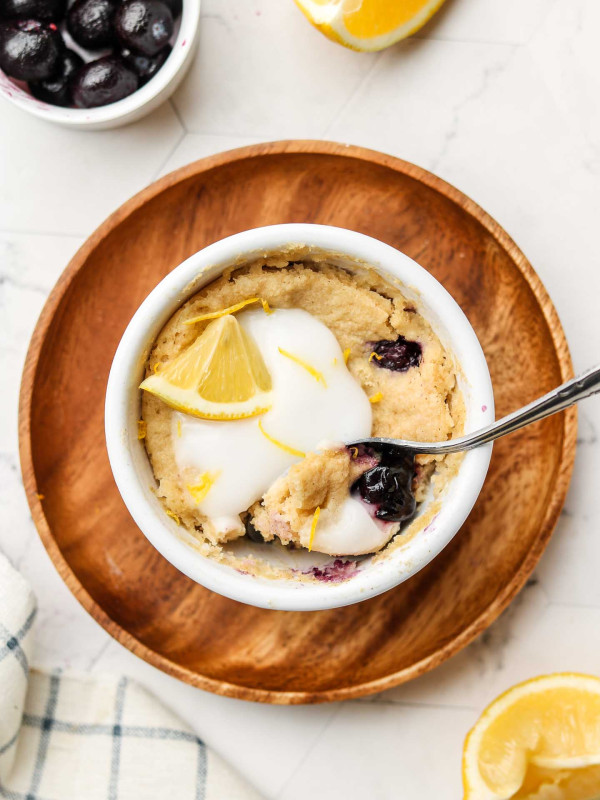 lemon blueberry muffin in a white bowl with yogurt on top