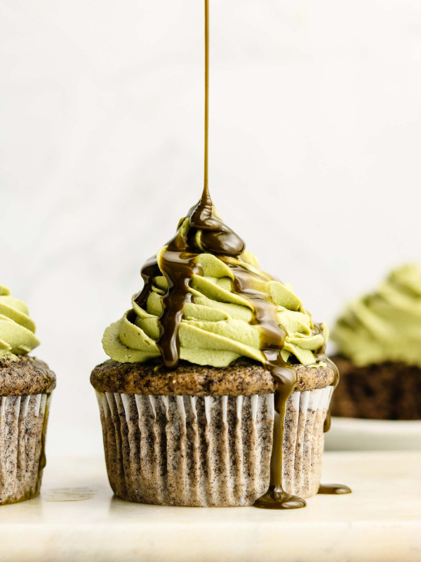 black sesame cupcakes with matcha whip cream on top drizzle shot