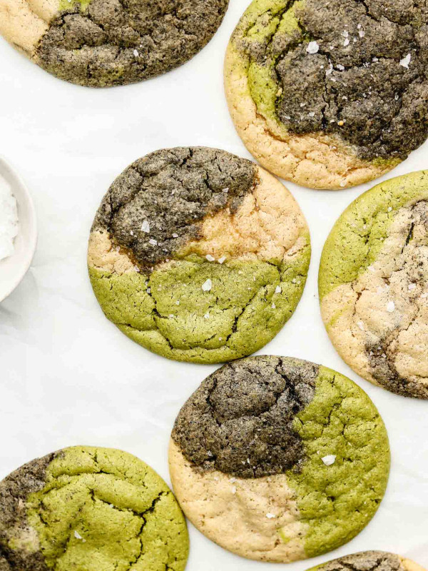 7 marbled sugar cookies on parchment paper with flaky fancy salt on top