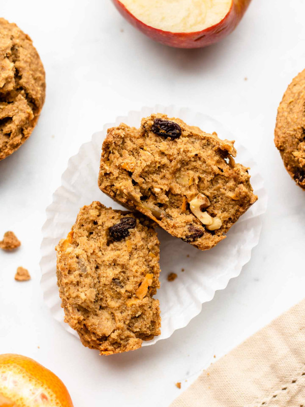 carrot apple muffins split in half on a muffin liner