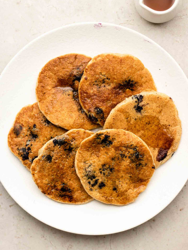 oat flour blueberry pancakes on a white plate