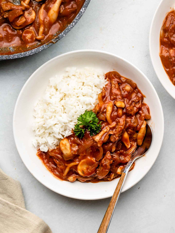 hayashi rice with tomatoes, mushrooms, onions and soy curls over rice and parsley on top