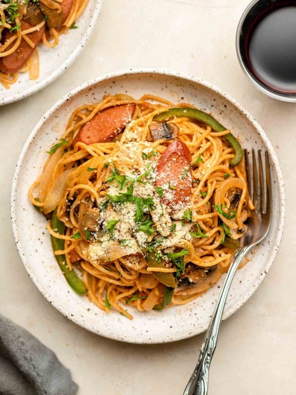 napolitan on a white speckled plate with parmesan and parsley