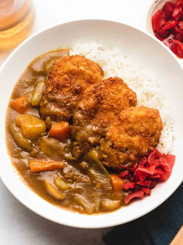 vegan katsu curry with Japanese rice in a white bowl