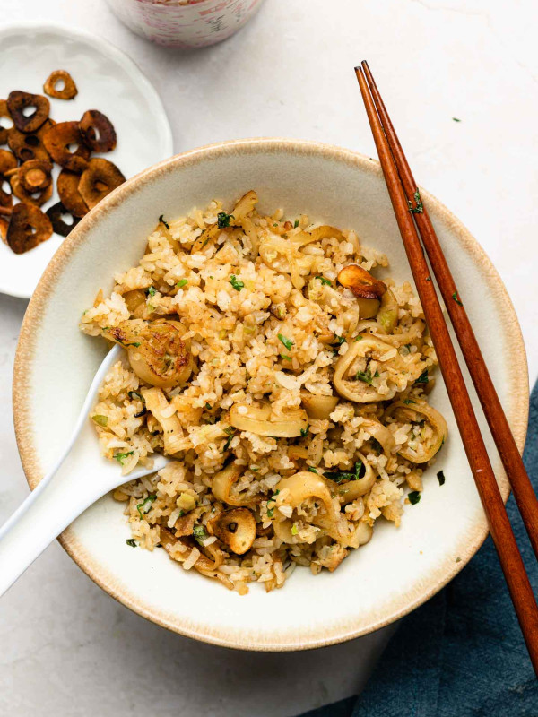 japanese garlic fried rice in a white bowl with gyoza