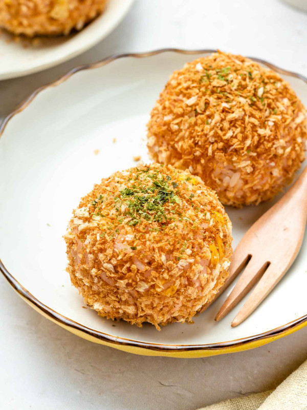 rice croquette on a white plate with parsley on top