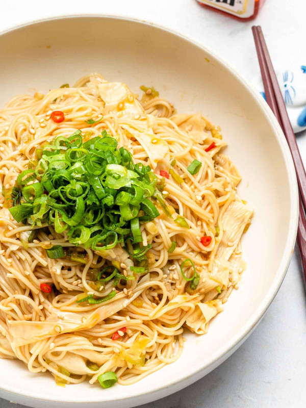 somen noodles with scallions in a white bowl half shot
