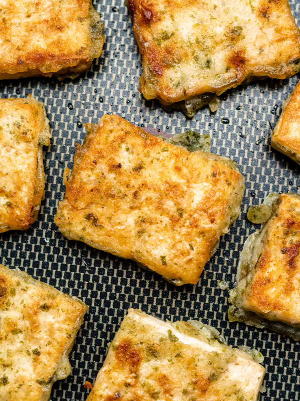 crispy pan fried tofu on a non-stick skillet