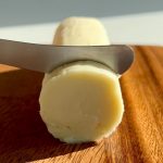 dairy free butter on a brown cutting board