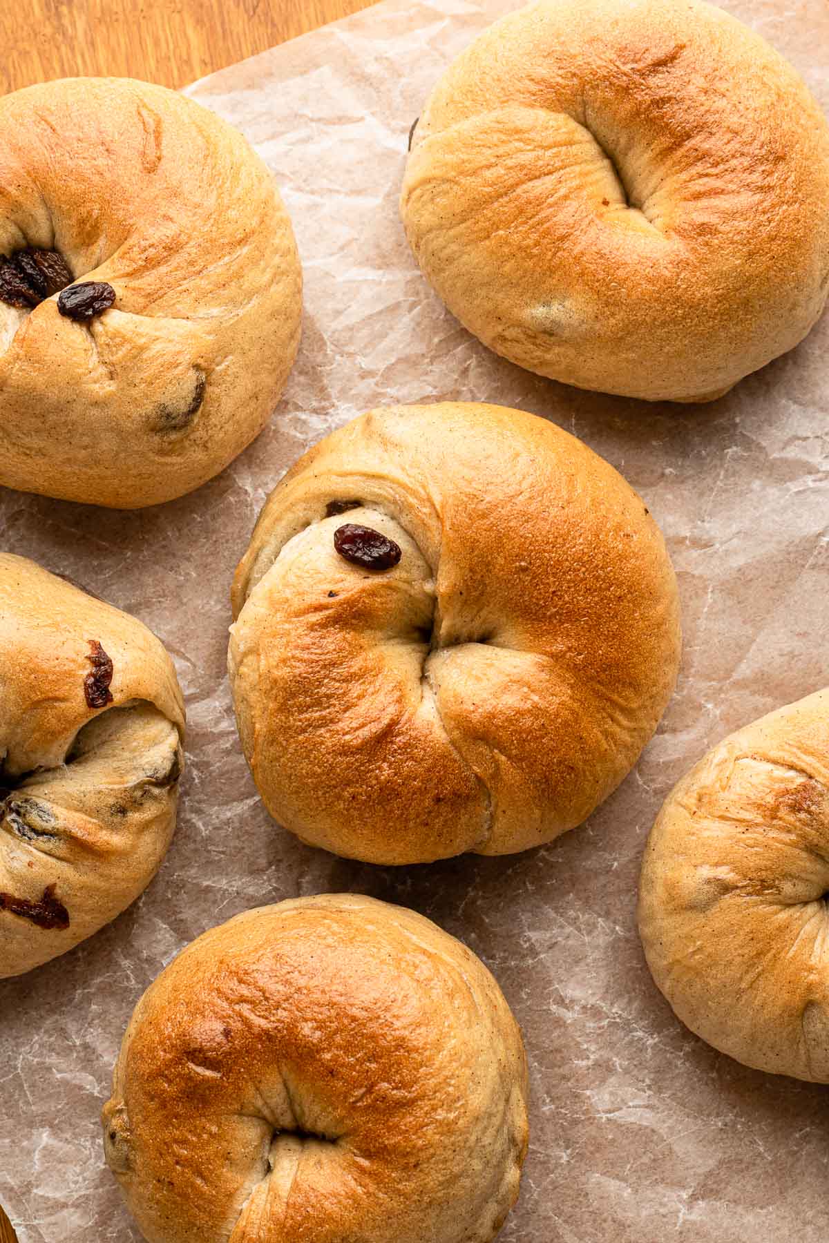 cinnamon raisin bagels on parchment paper