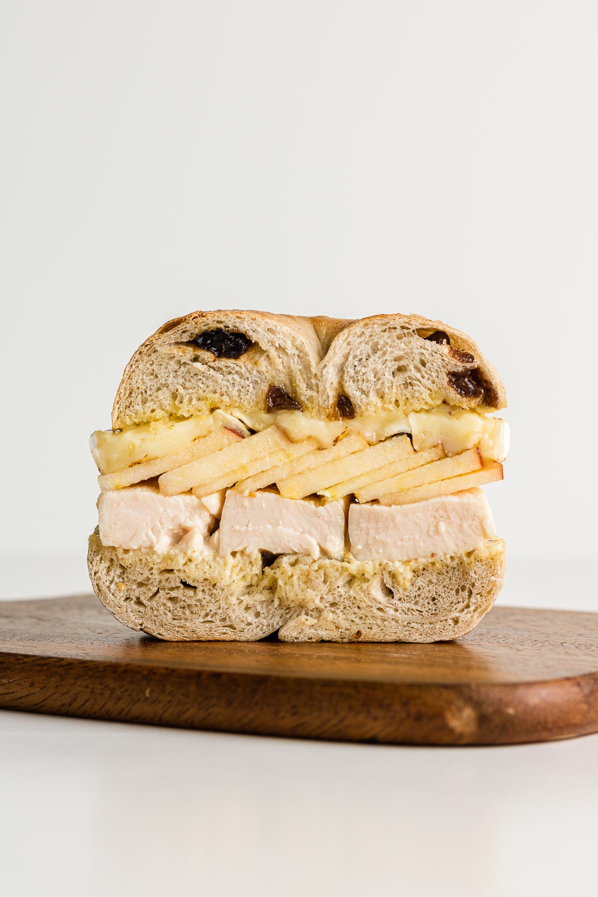 cinnamon raisin bagel ham apple sandwich cut in half