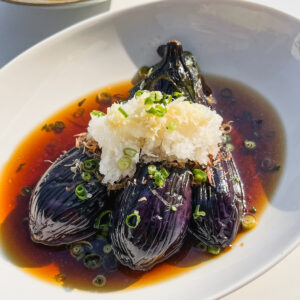 fried japanese eggplant in savory broth topped with daikon and ginger