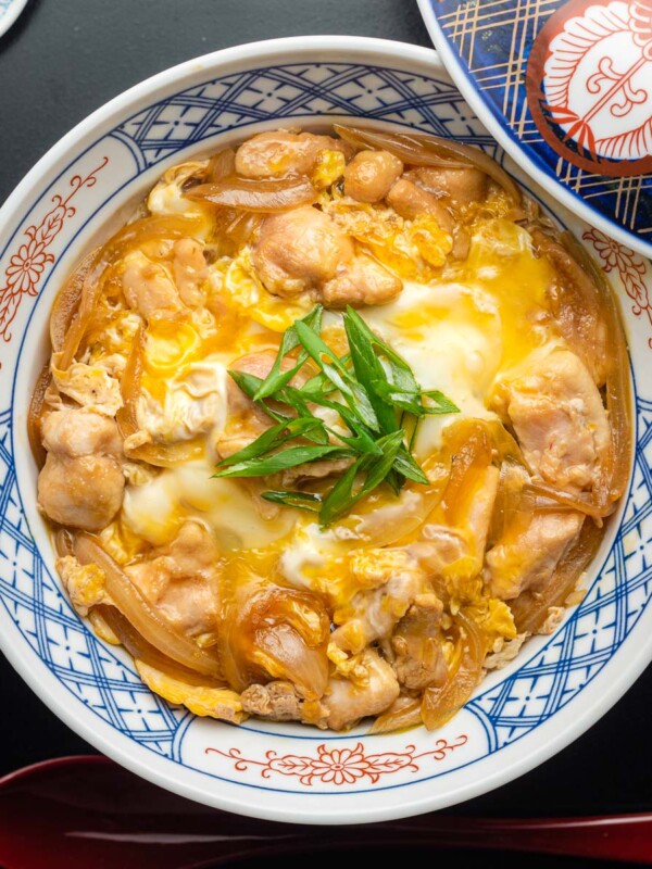 oyakodon (egg and chicken rice bowl) in a nishiki japanese rice bowl on a tray