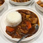 japanese chicken curry on a white plate with shot grain rice