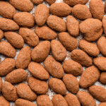 cocoa dusted almonds with candied almonds and chocolate on parchment paper