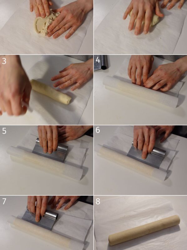 rolling cookie dough on parchment paper with a bench scraper