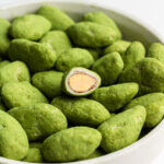 matcha candied white chocolate almonds in a bowl