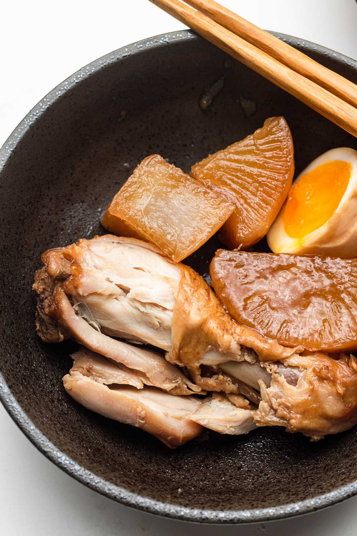 half eaten Rice Cooker Chicken and Radish with soft boiled egg
