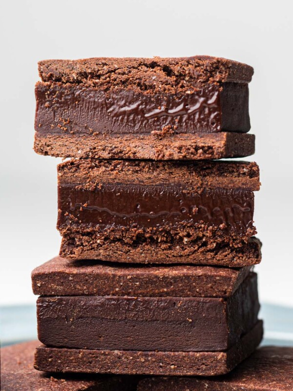 nama choco sandwich cookies (raw chocolate) stacked on a blue plate