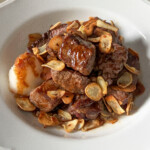 saikoro steak bites with garlic soy butter sauce in a white bowl