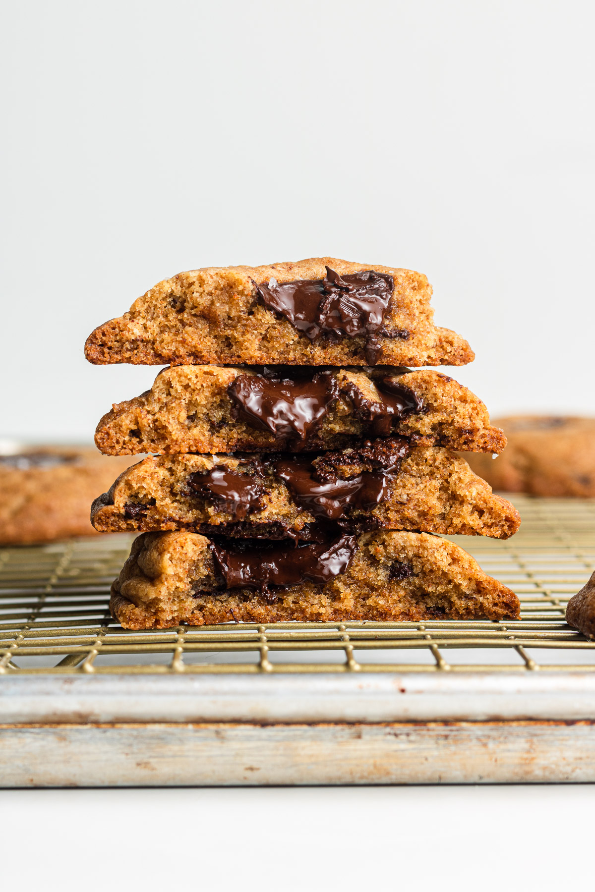brown butter chocolate chip cookies cross section on a cooling rack