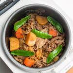 meat and potatoes in a rice cooker pot
