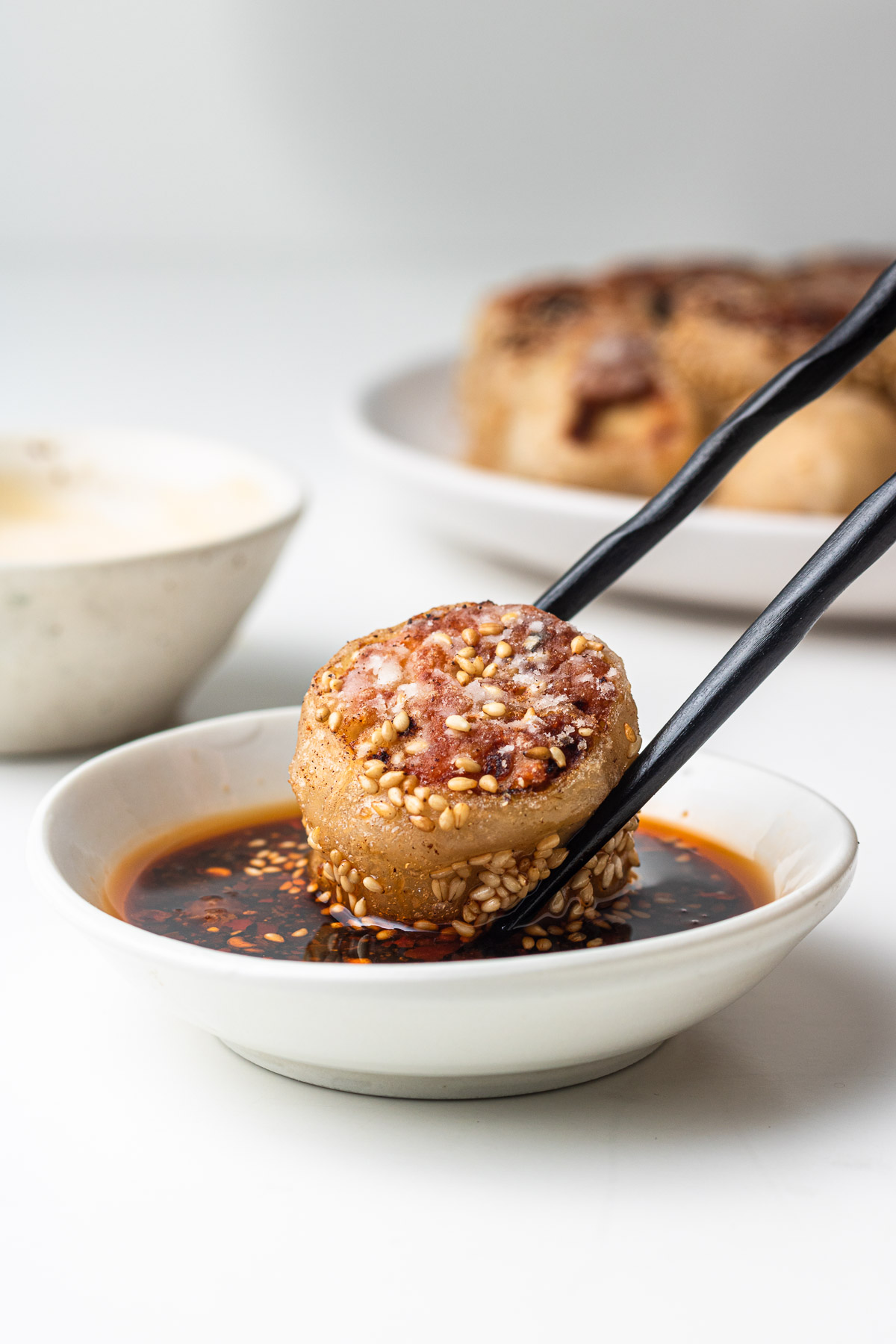 dipping rice paper rolled dumplings into sauce