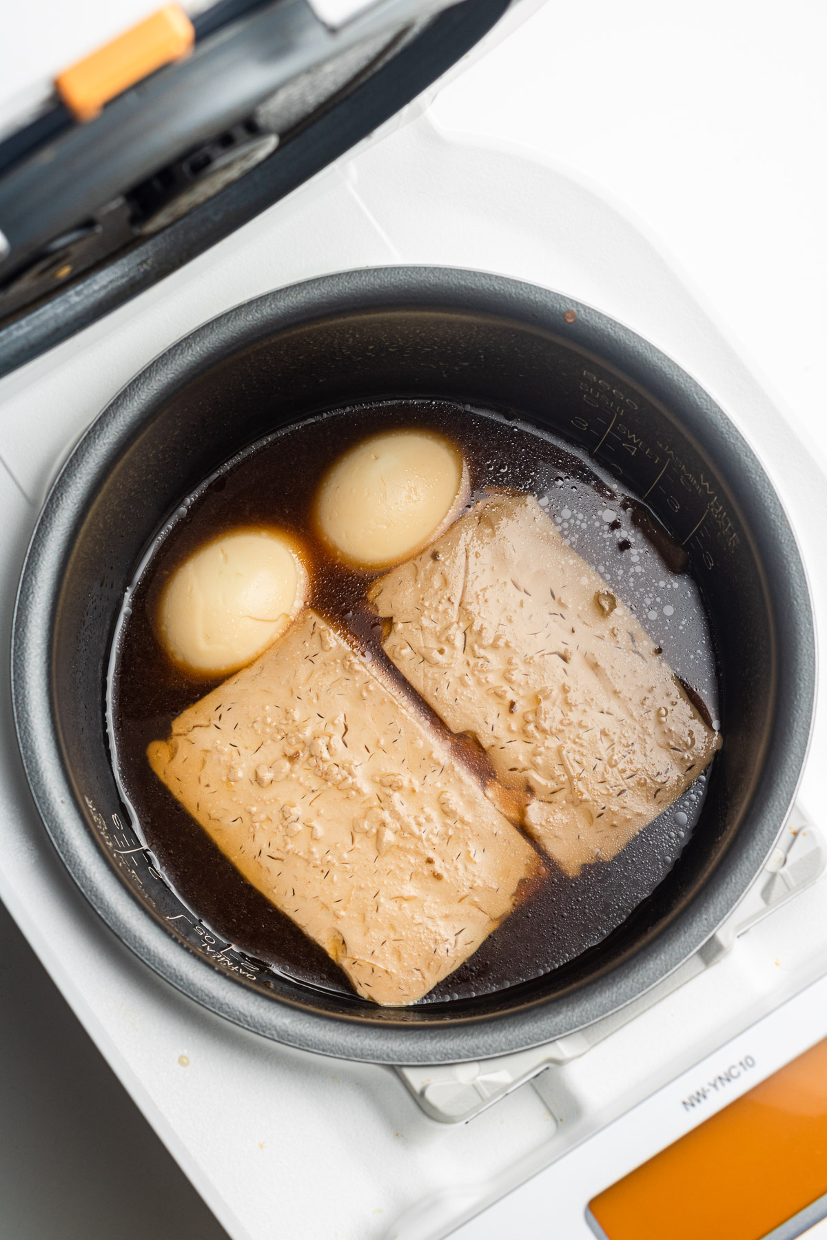 tofu and eggs in a rice cooker with broth