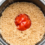 whole tomato rice in a rice cooker pot