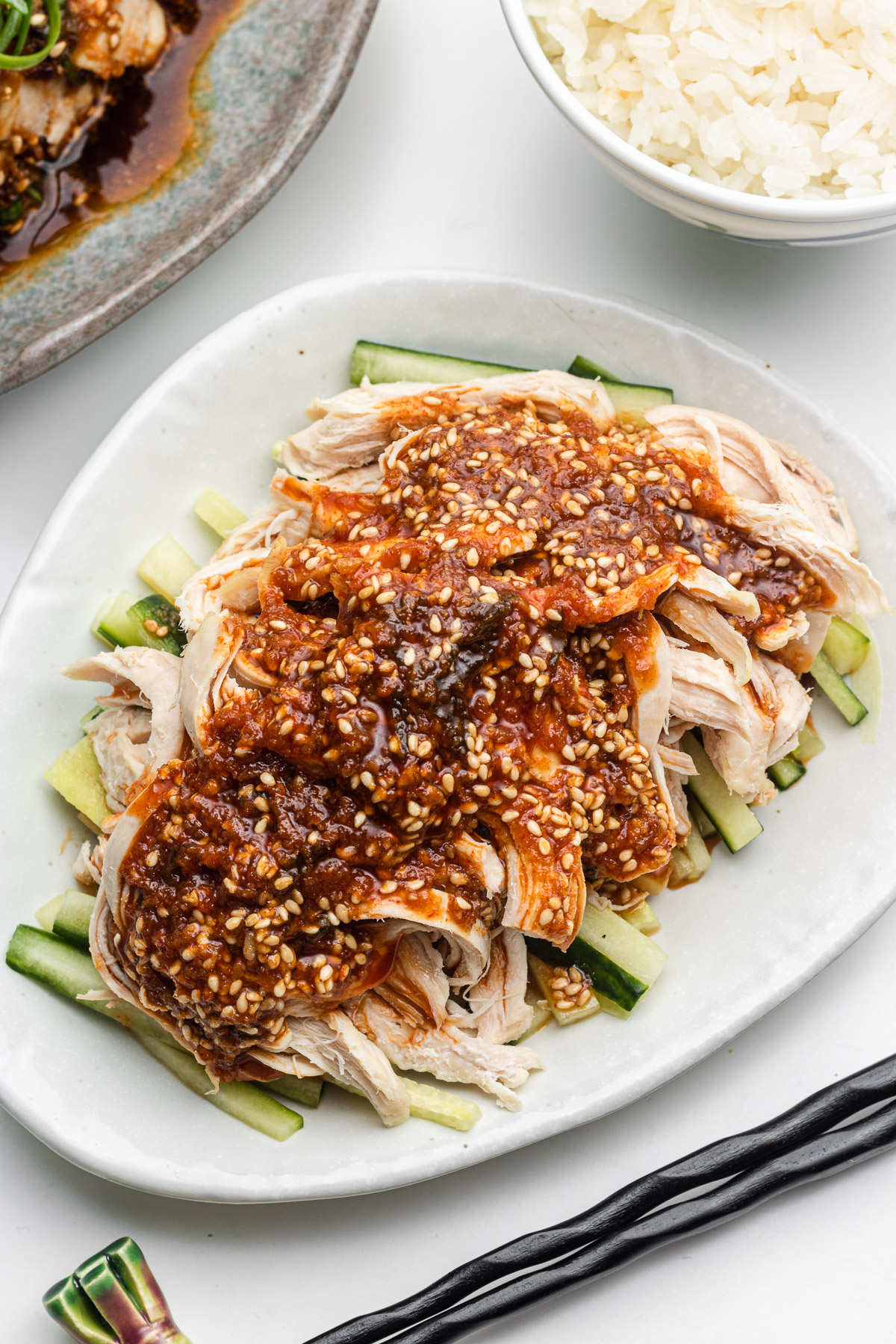 chicken breast with miso chili oil sauce over cucumbers