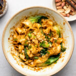 peanut butter noodles in a bowl with chili crisp and bok choy