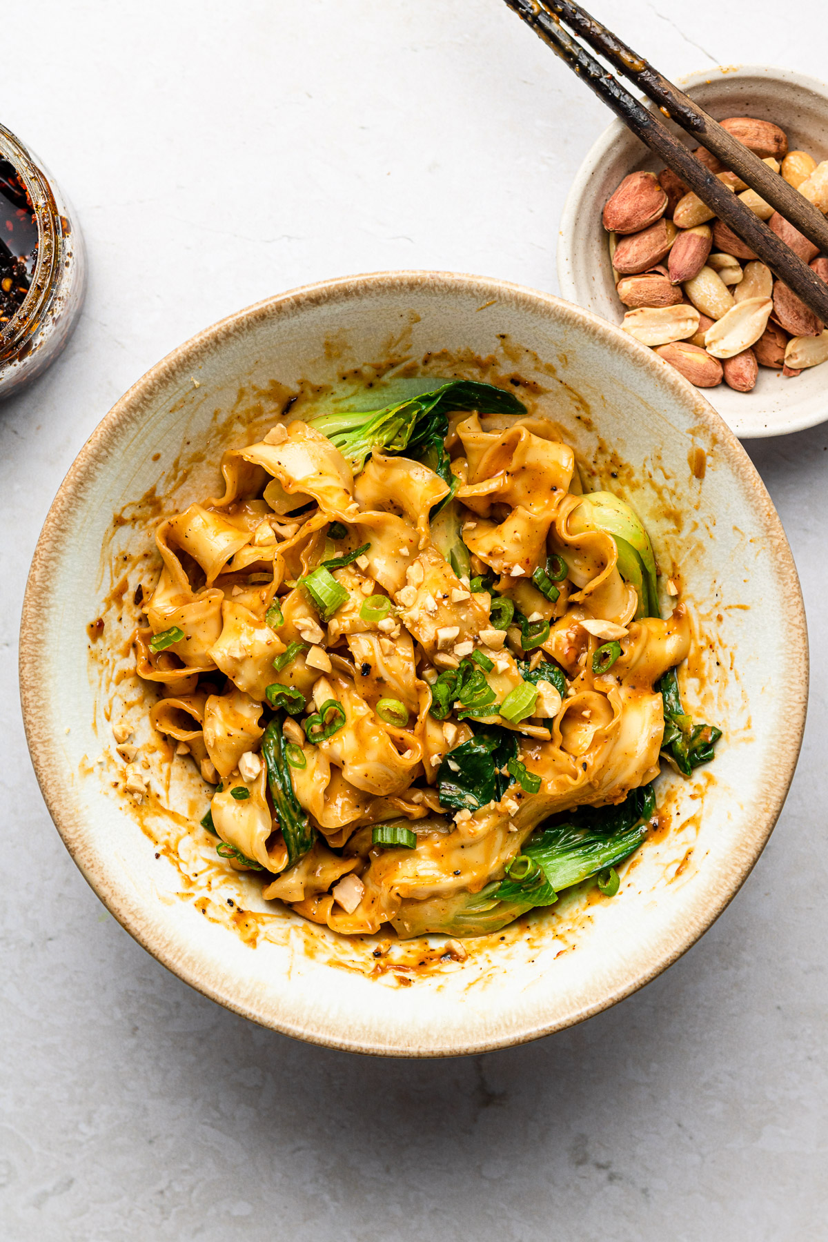 peanut butter noodles in a bowl with chili crisp and bok choy