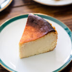 rich and creamy cheesecake on a dessert plate on a wooden table