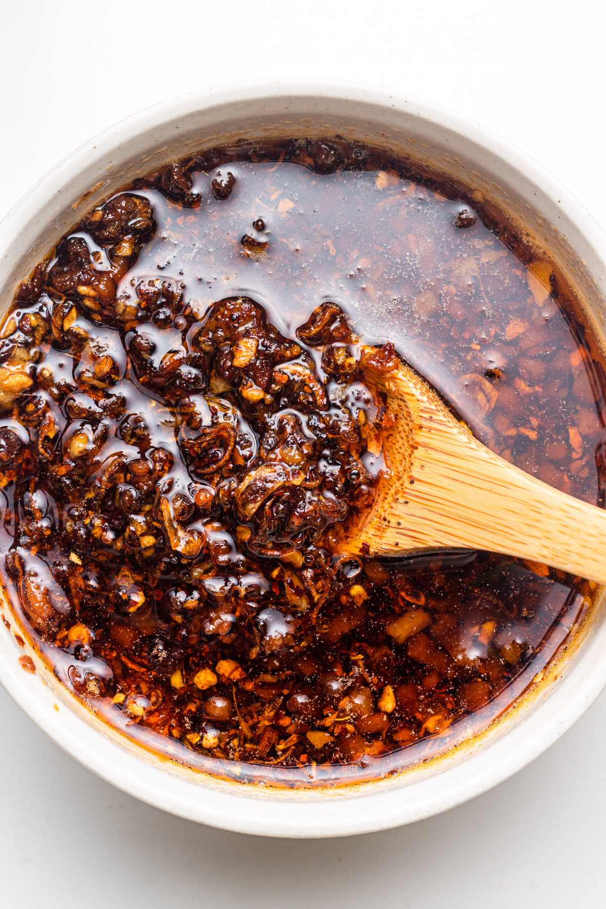 chili oil in a bowl scooping with a spoon