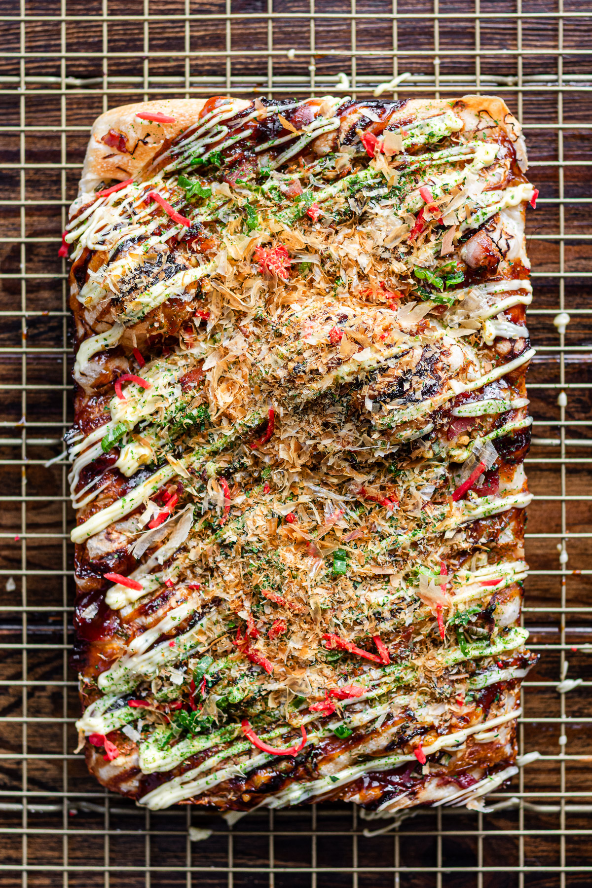 focaccia with okonomiyaki toppings such as cabage, kewpie mayo, ginger, bacon, cheese