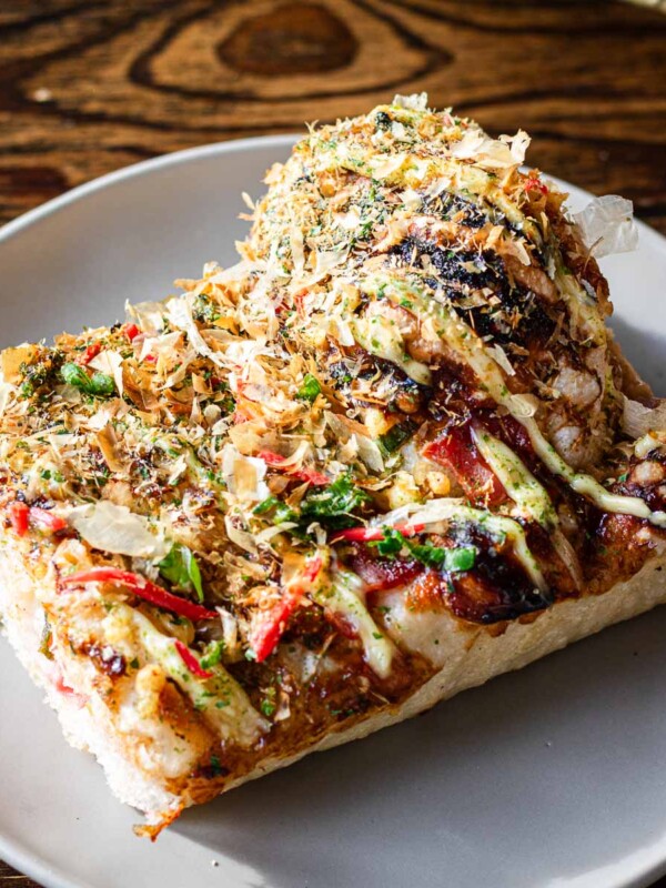 sliced focaccia with cabbage, mayo, vegetables, bacon and cheese