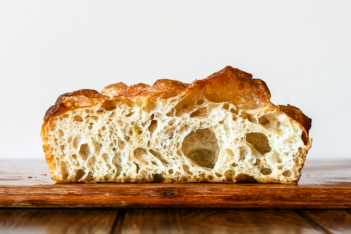 open crumb focaccia on a cutting board