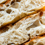 chewy butter focaccia sliced on a cutting board