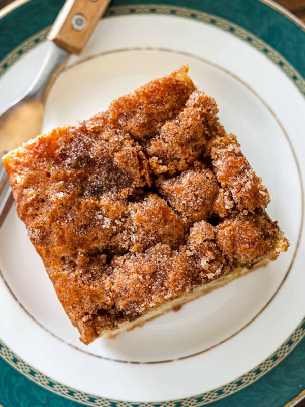 crunchy cinnamon sugar apple cake on a green dessert plate