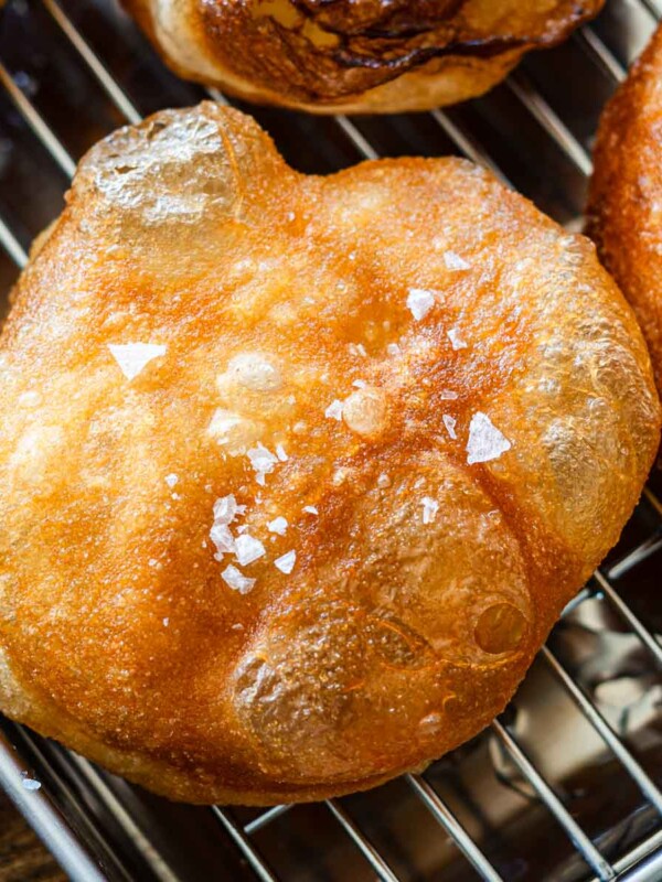 golden focaccia on a wire rack topped with flaky salt