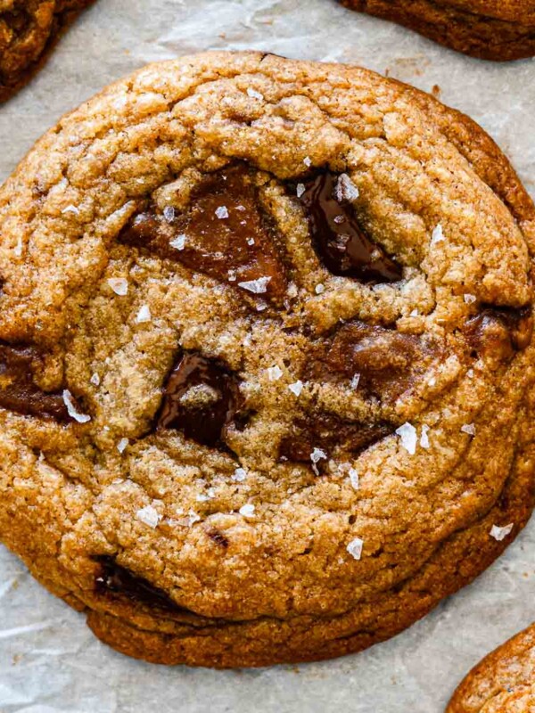 brown butter chocolate chip cookies with miso toffee on parchment paper
