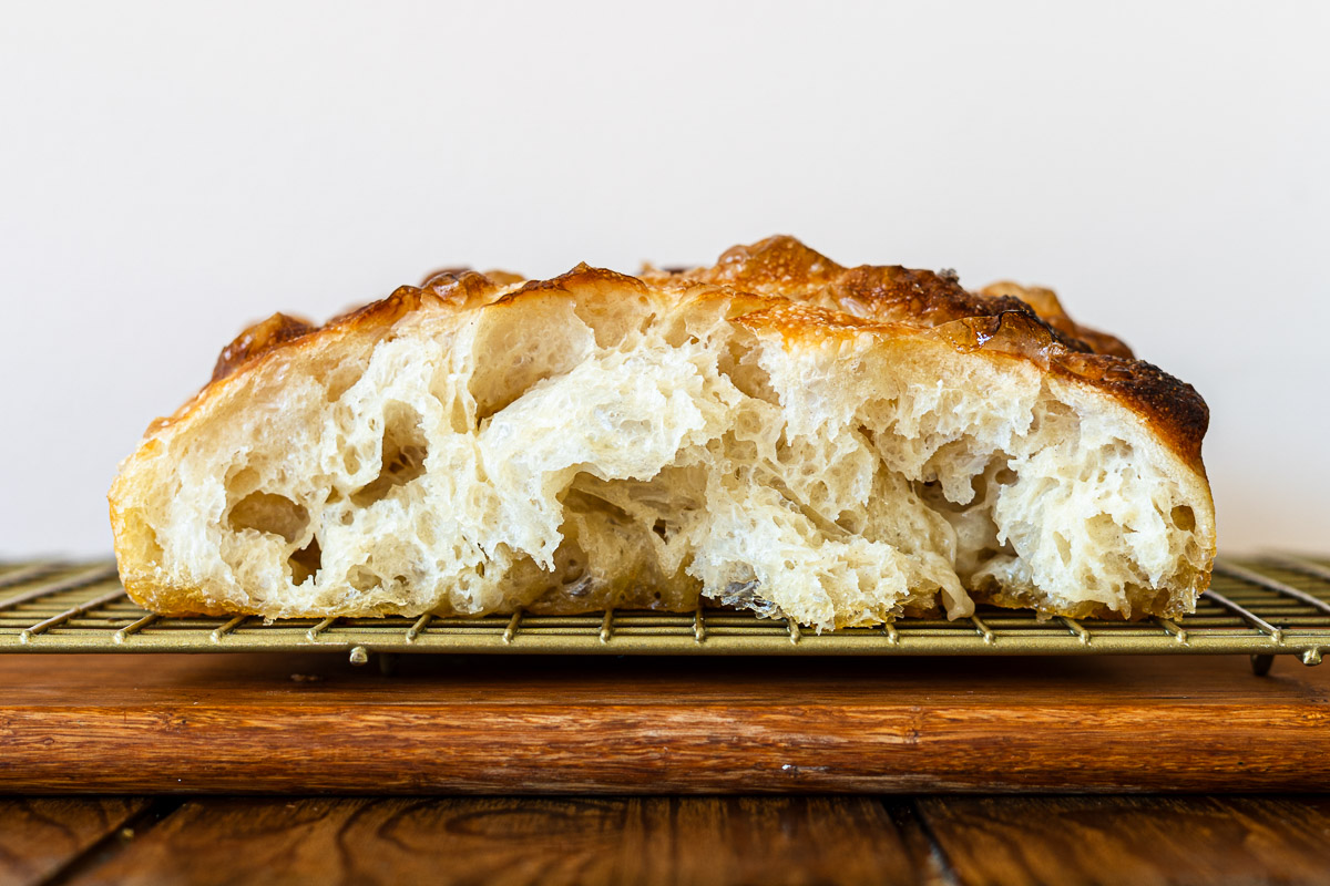 shio pan focaccia on a cooling rack with flaky crumb showing