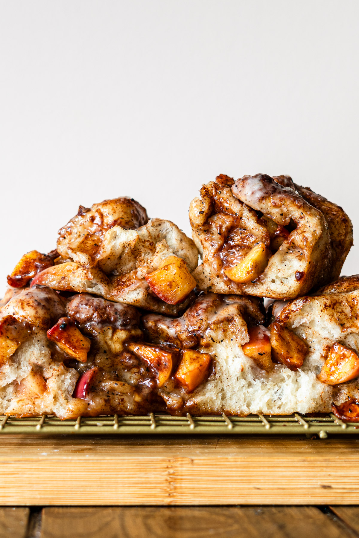 apple fritter focaccia pieces stacked with brown butter maple glaze