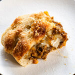 slice of kare pan focaccia with cheese on a white plate